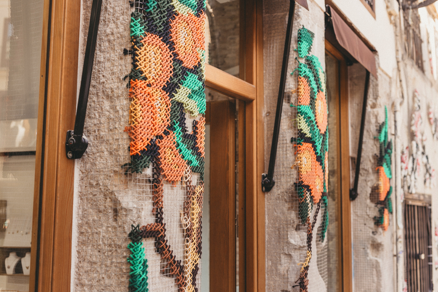 Anartxy — detail of embroidered orange tree panels with awning brackets