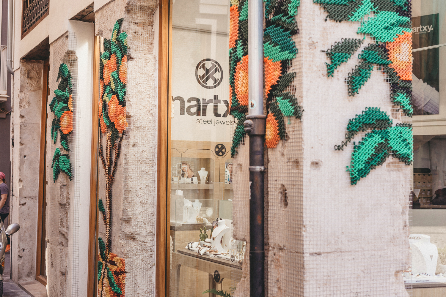 Anartxy — side view of facade with embroidered trees framing the shopfront
