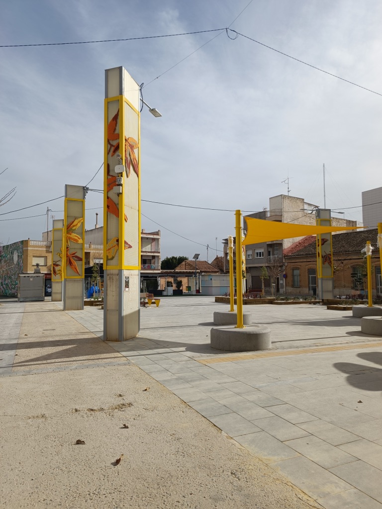 Katarsis — lampposts with embroidered autumn leaves, plaza view